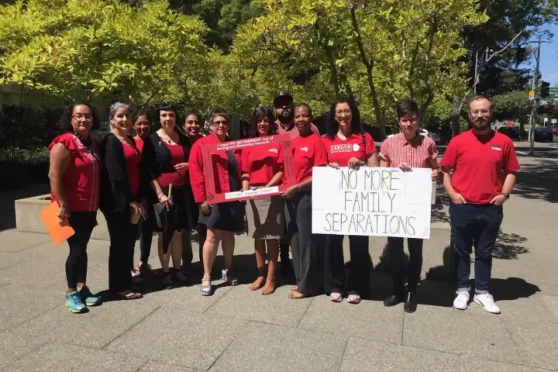 A group of people holding a sign