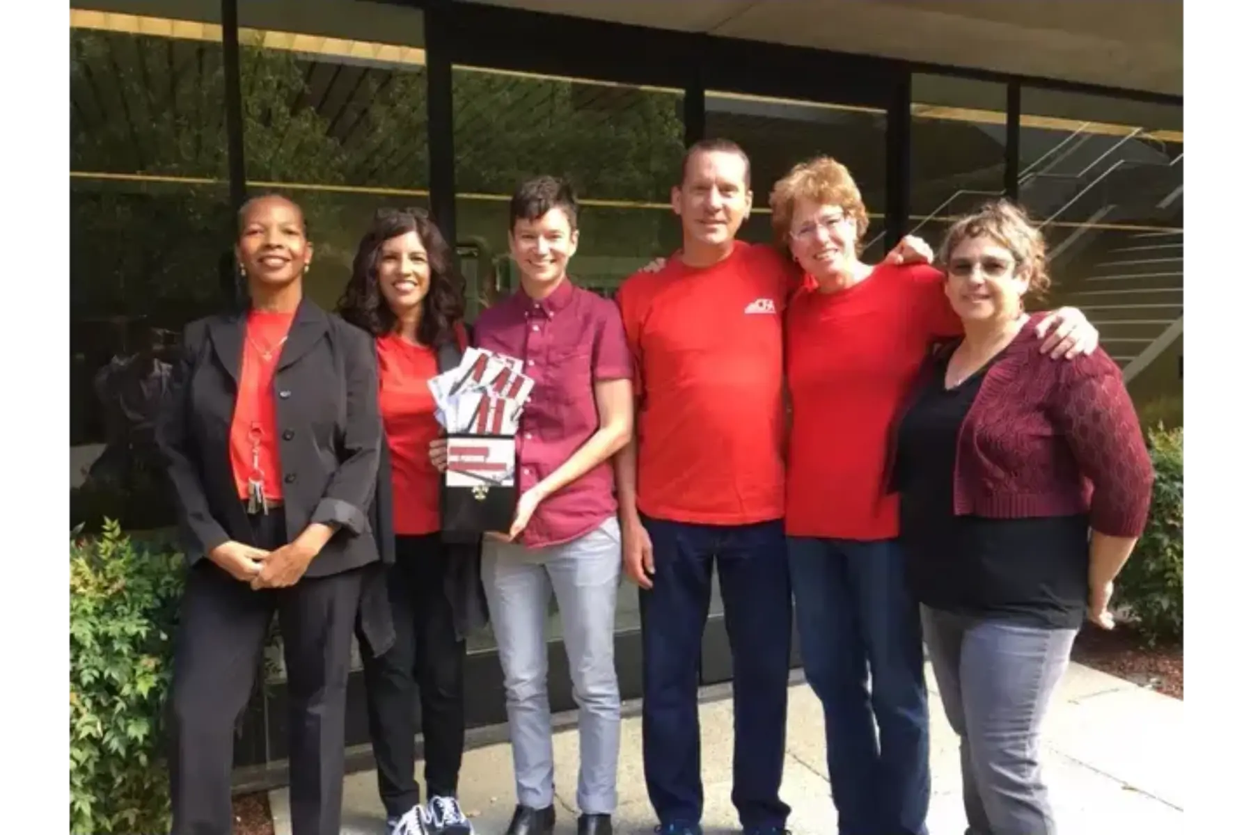 A group of people holding a sign