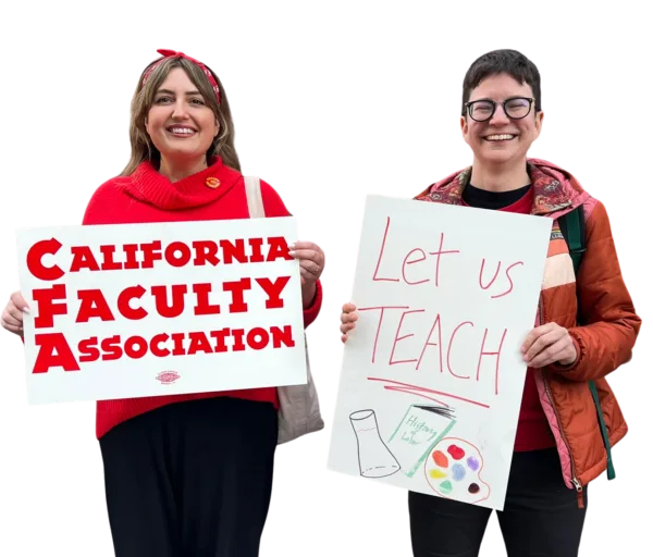 Two women pose with signs