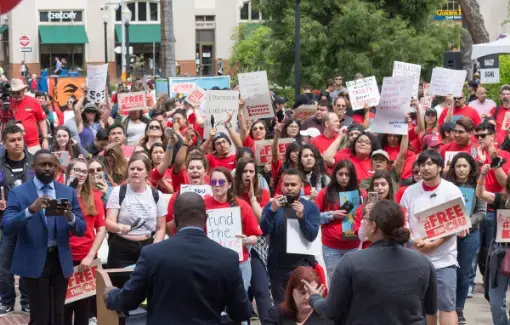 CFA members dress in Red for Ed tshirts and hold signs as they rally at the Sacramento Capitol for improved funding for the CSU.