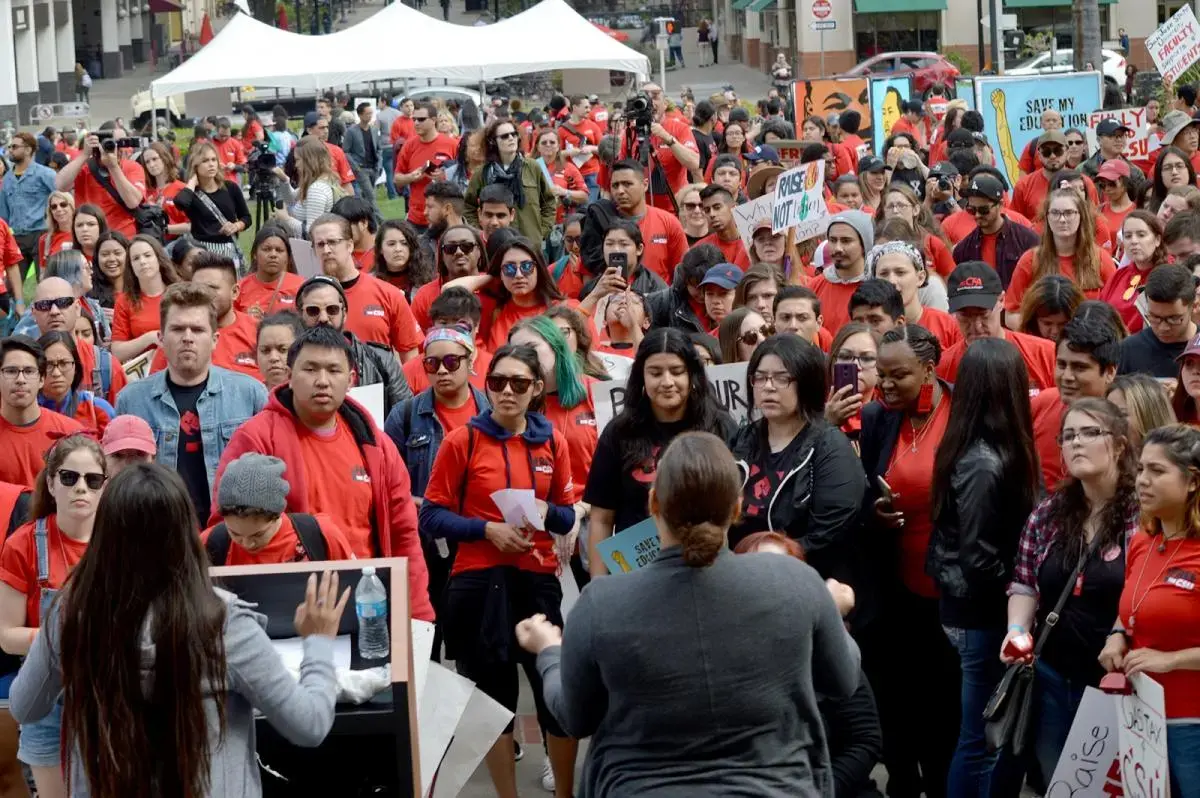 CFA members and students wear red shirts at a Sacramento rally advocating for more CSU funding.