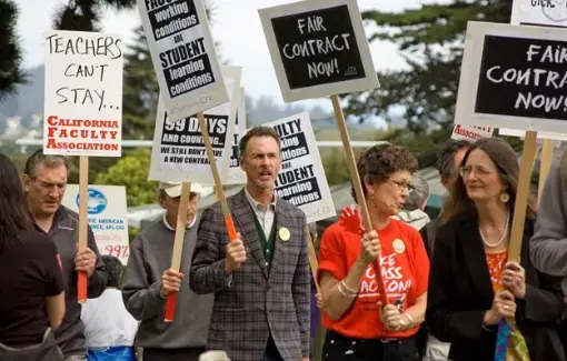 San Francisco State faculty members show their solidarity with signs.