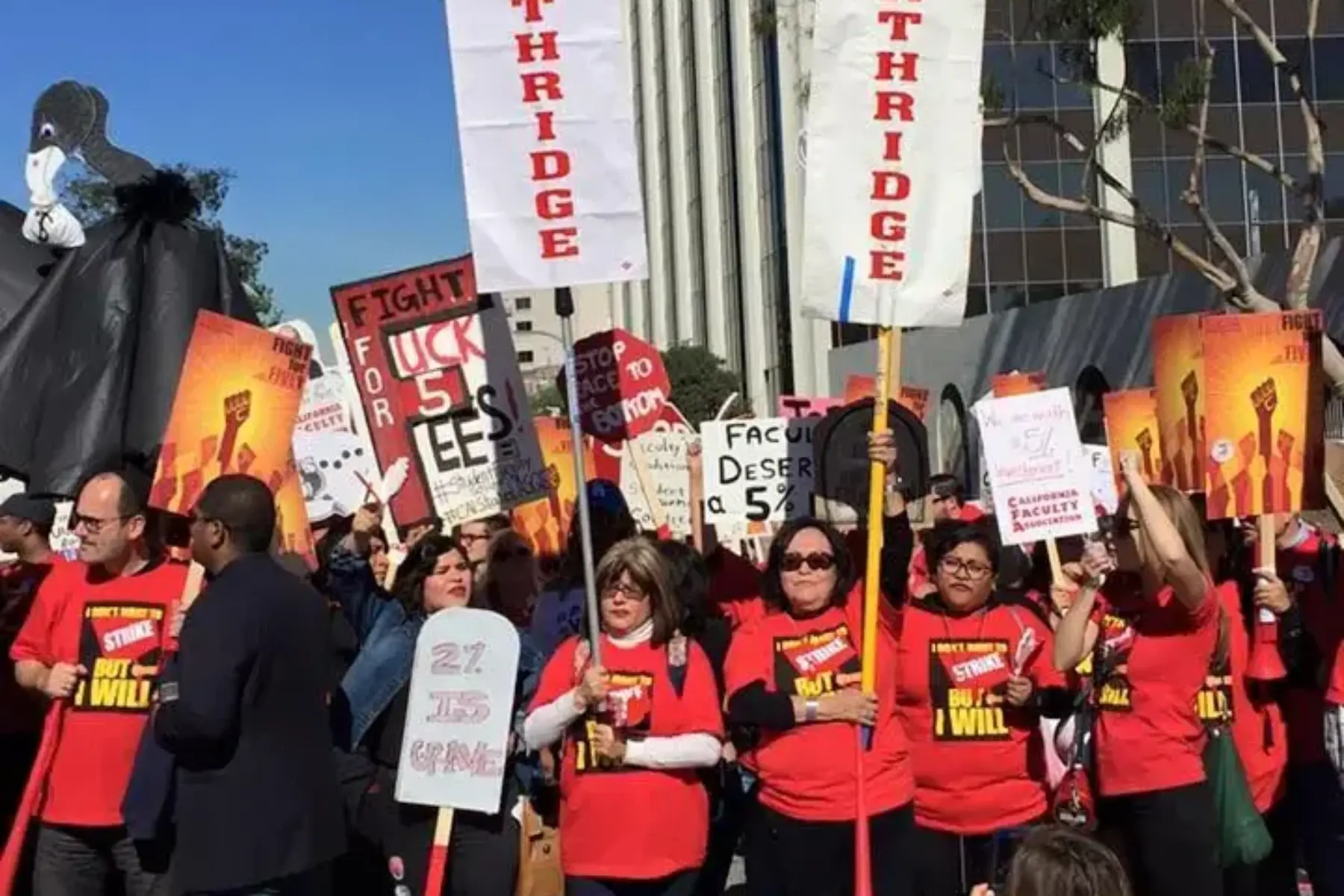 Large group of people wearing red shirts hold rally signs and white banners that read CFA Northridge.