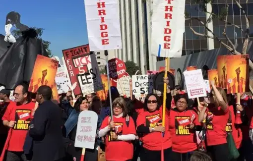 Large group of people wearing red shirts hold rally signs and white banners that read CFA Northridge.