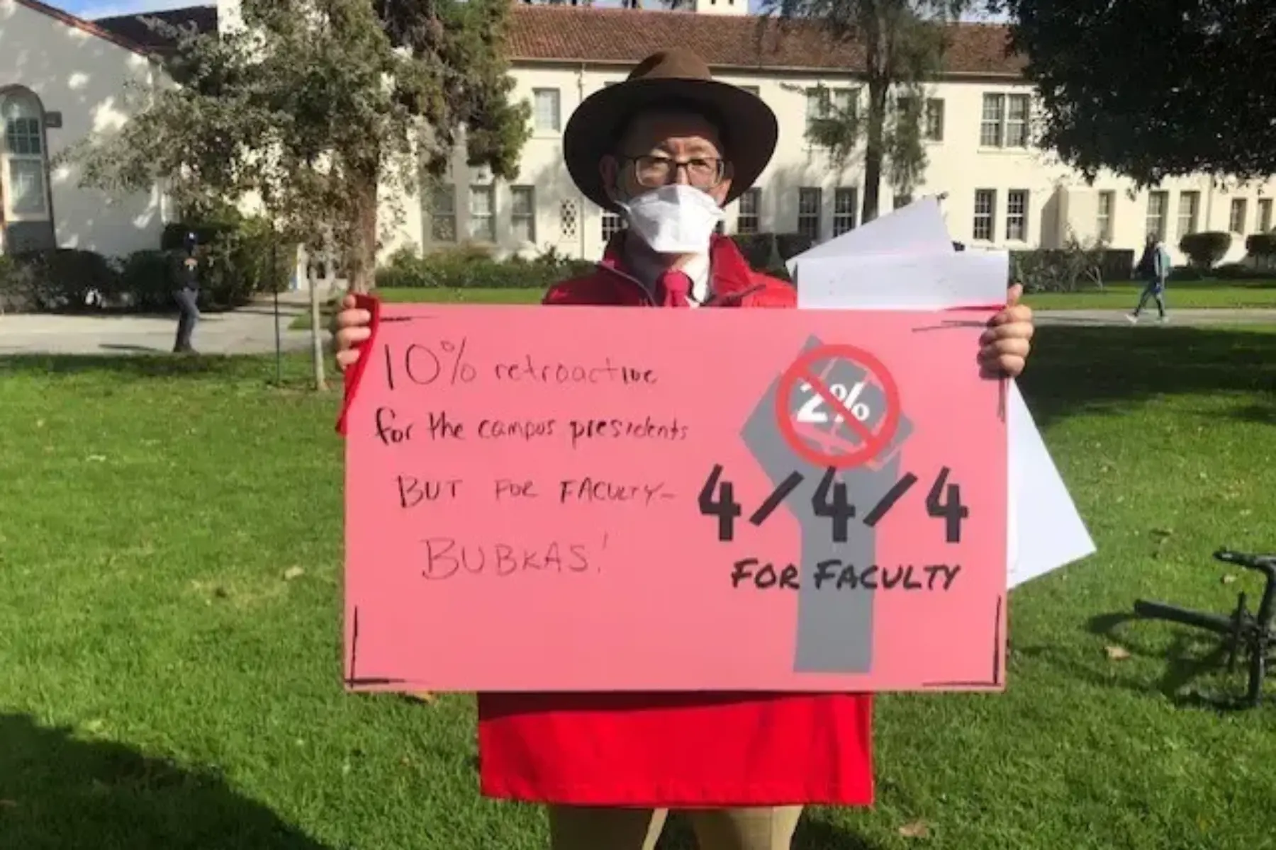Image of person with a poster saying 4% for faculty