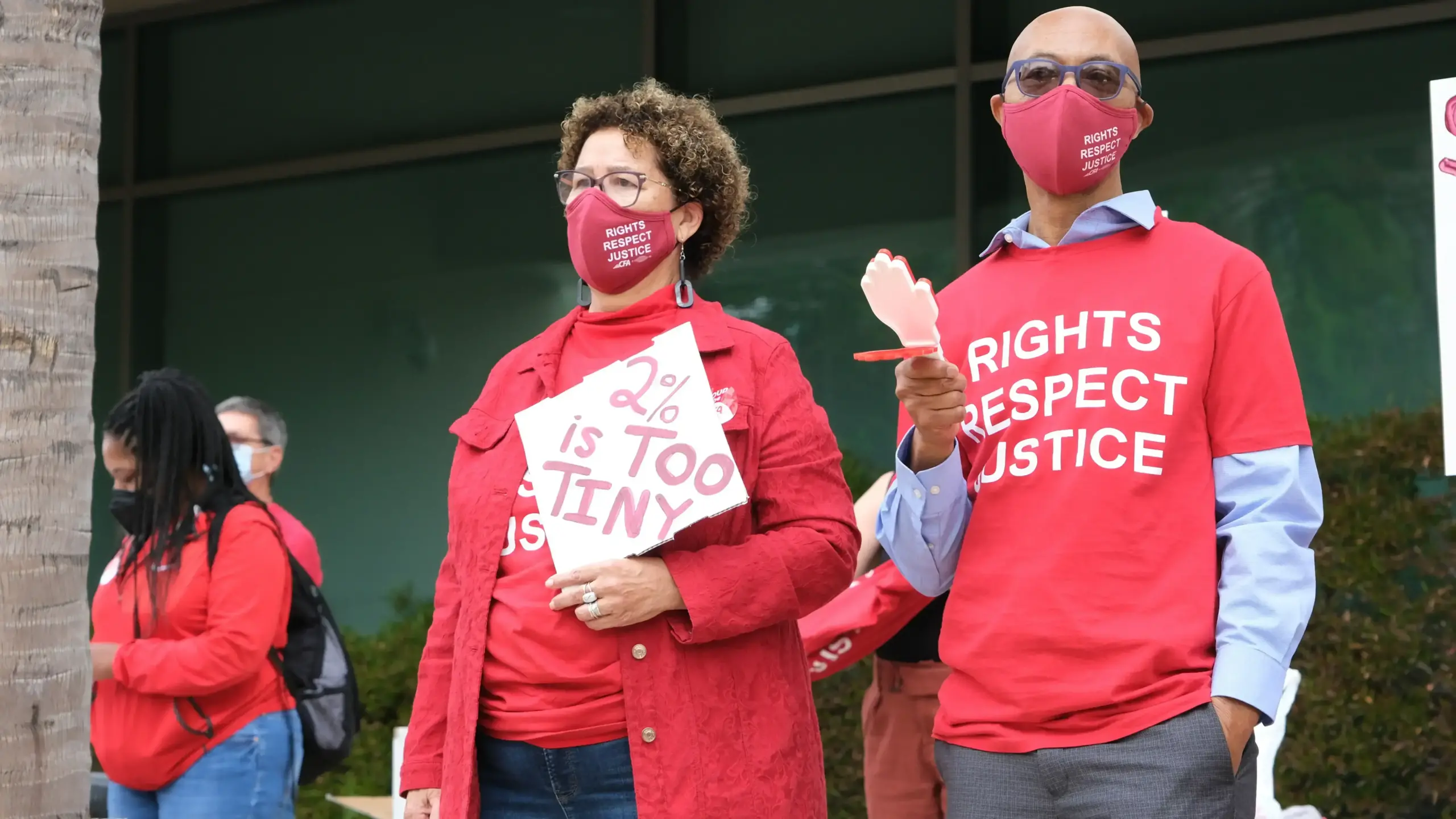 photo for 2 people wearing red tshirt standing outside