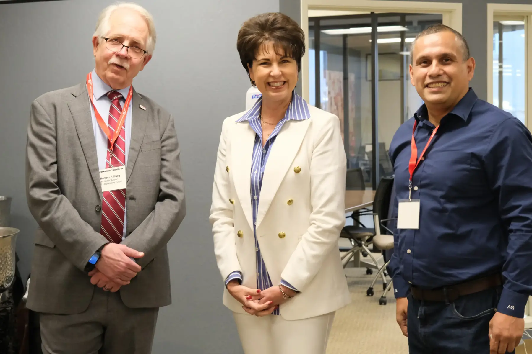 Three people pose for a photo.