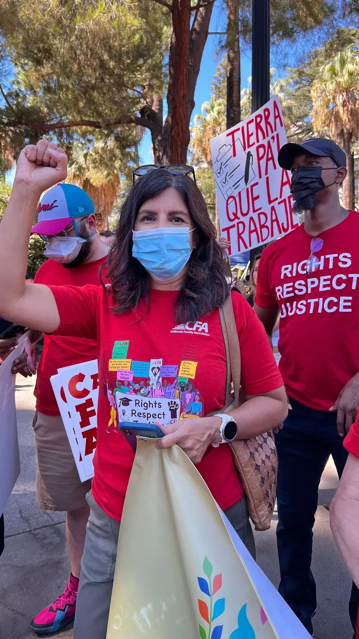 woman in a red t-shirt with fists in the air