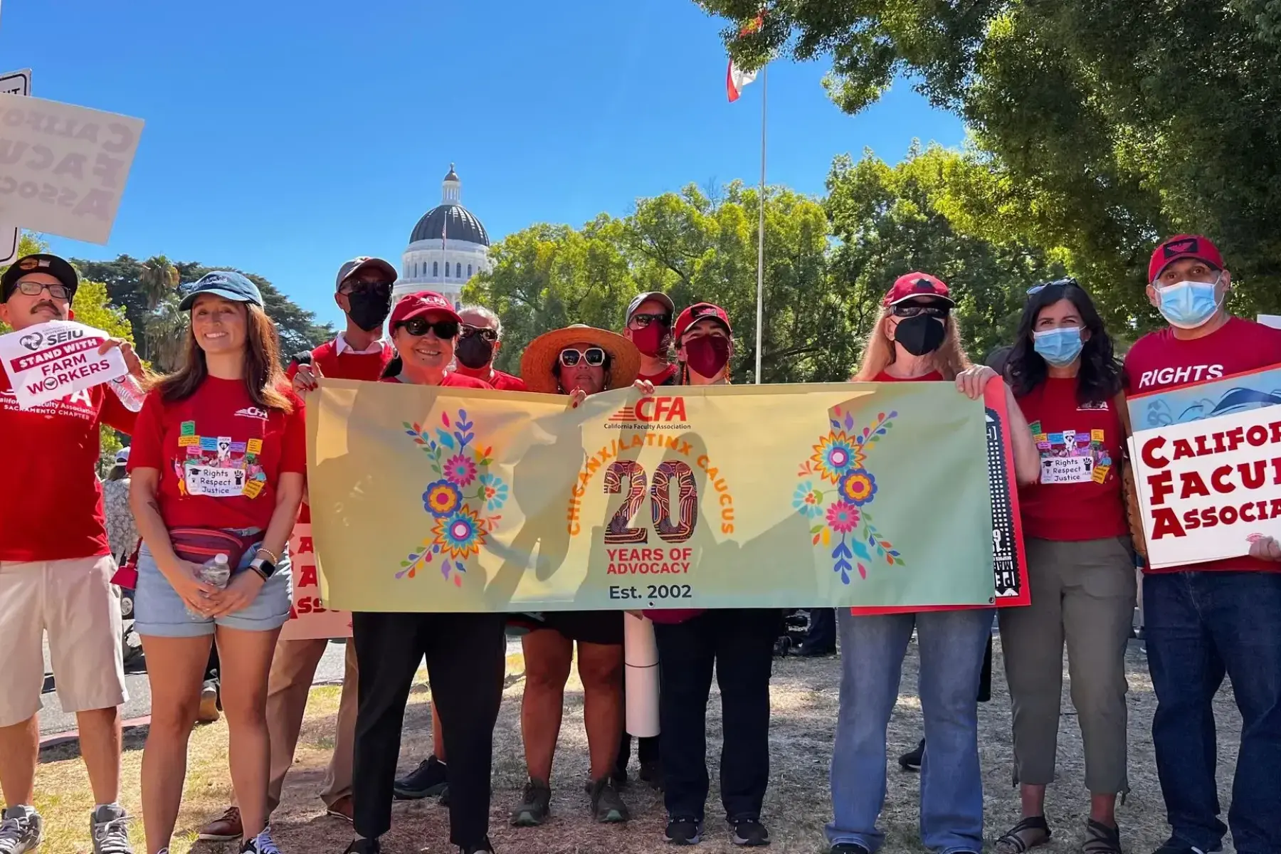 a group of people holding a banner for a picture