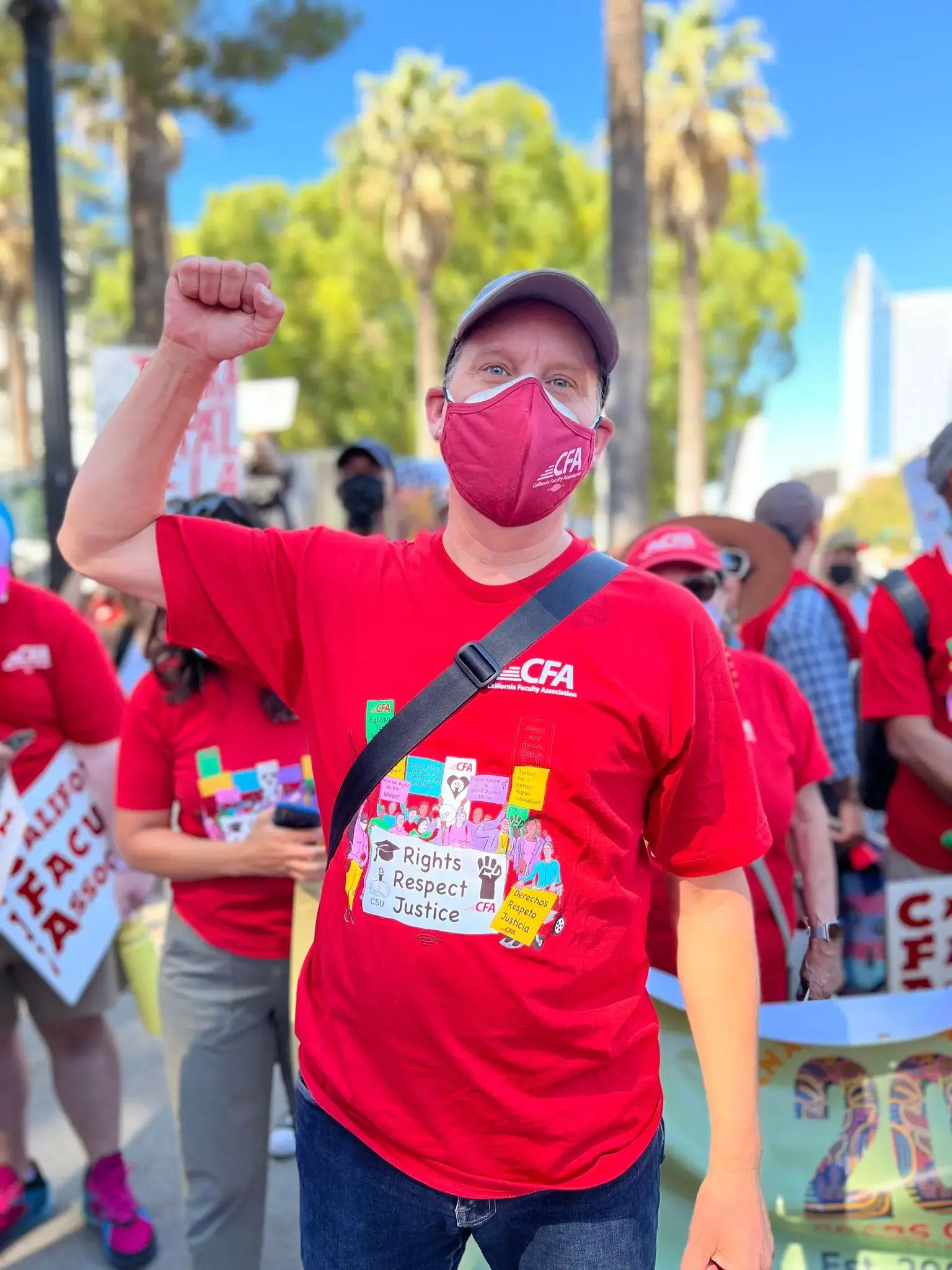 Man in a red shirt with fist in air