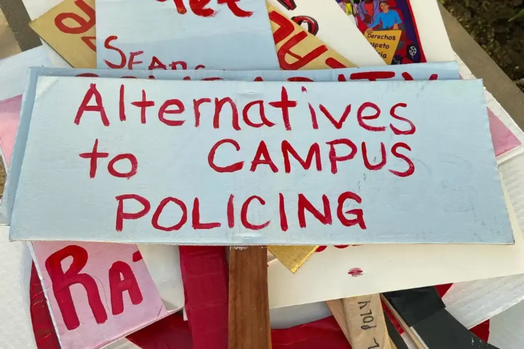 Sign saying "Alternatives to campus policing"