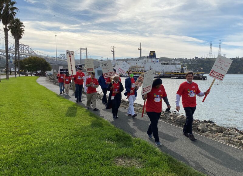 A group of people marching with signs.