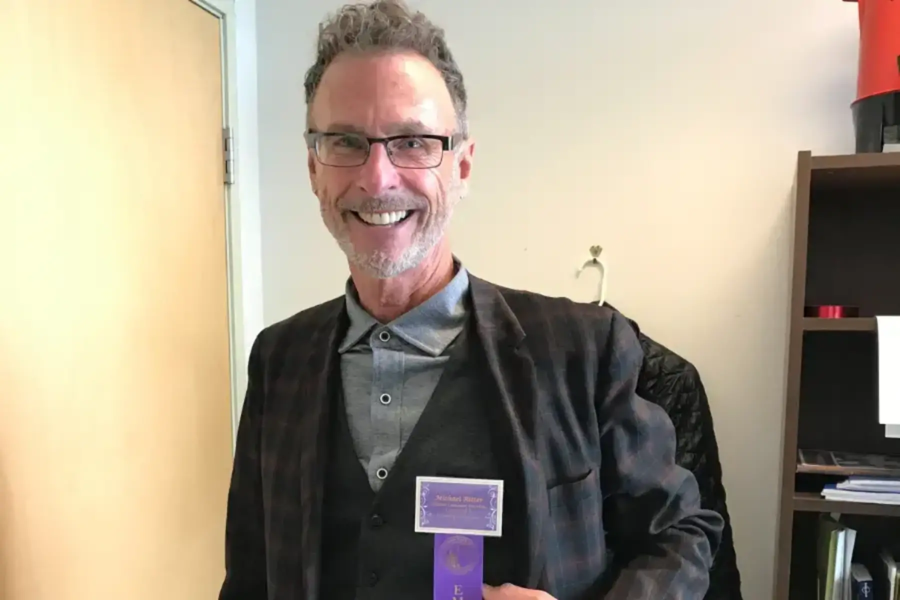 Man in a suit smiling for a photo