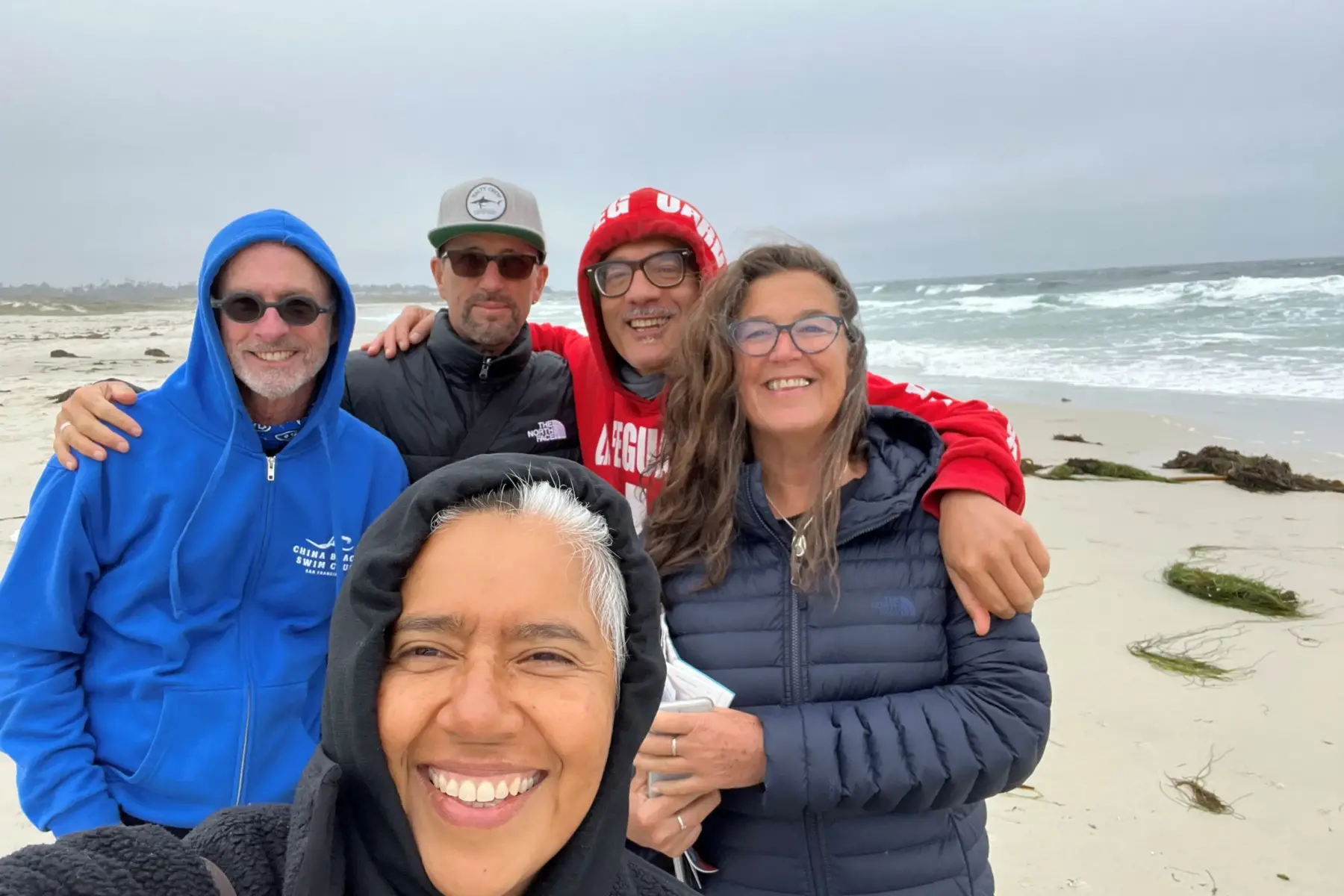 A group of people taking a photo at the beach