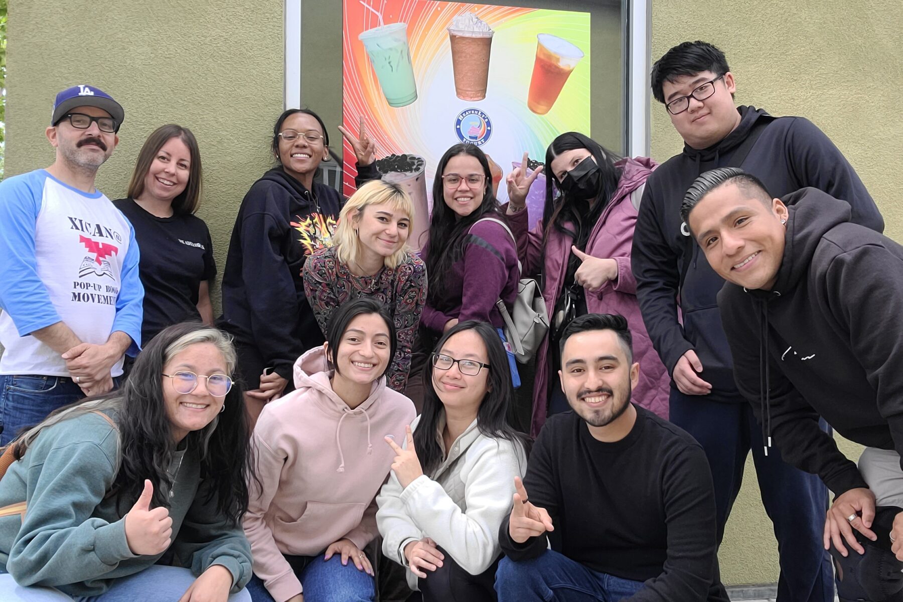 A group of students huddle together for a photo.
