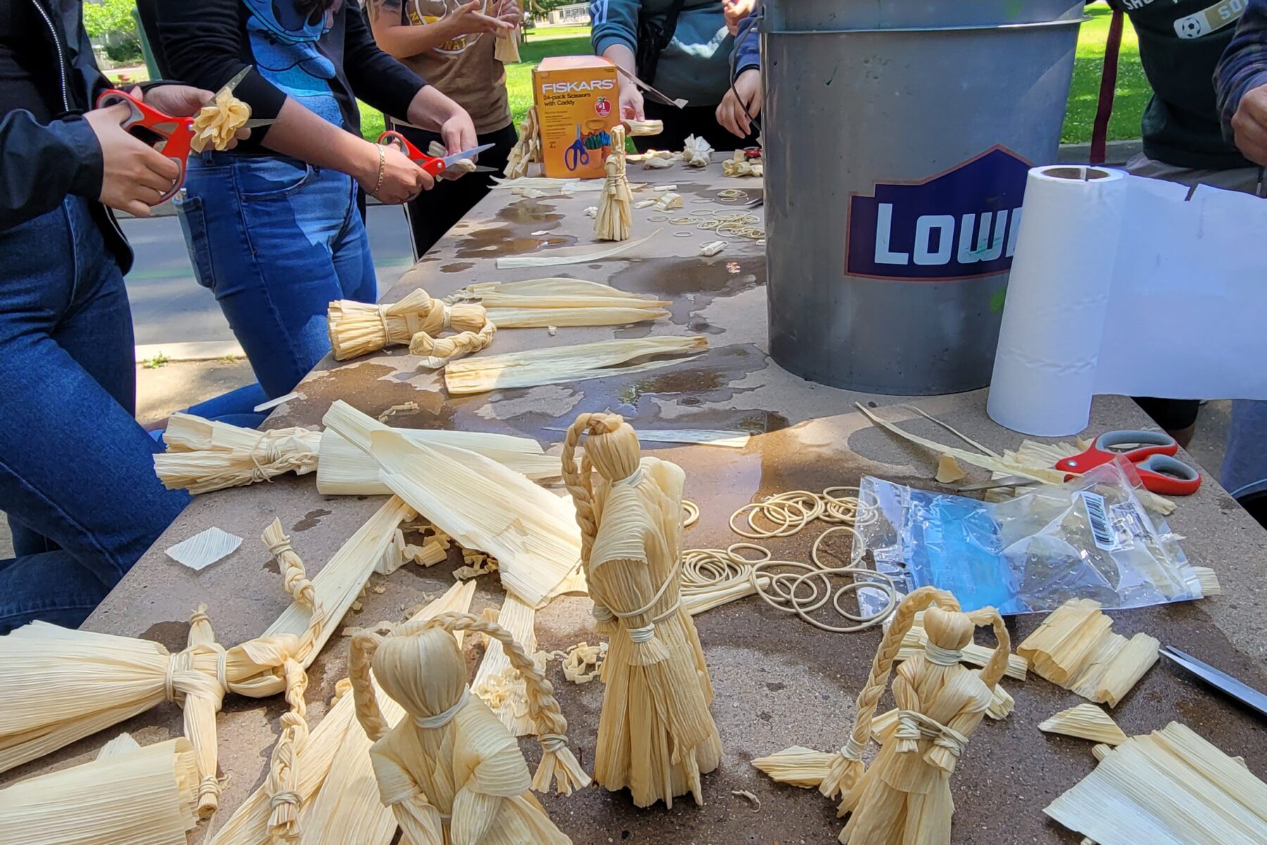 Group activity of husk dolls with students
