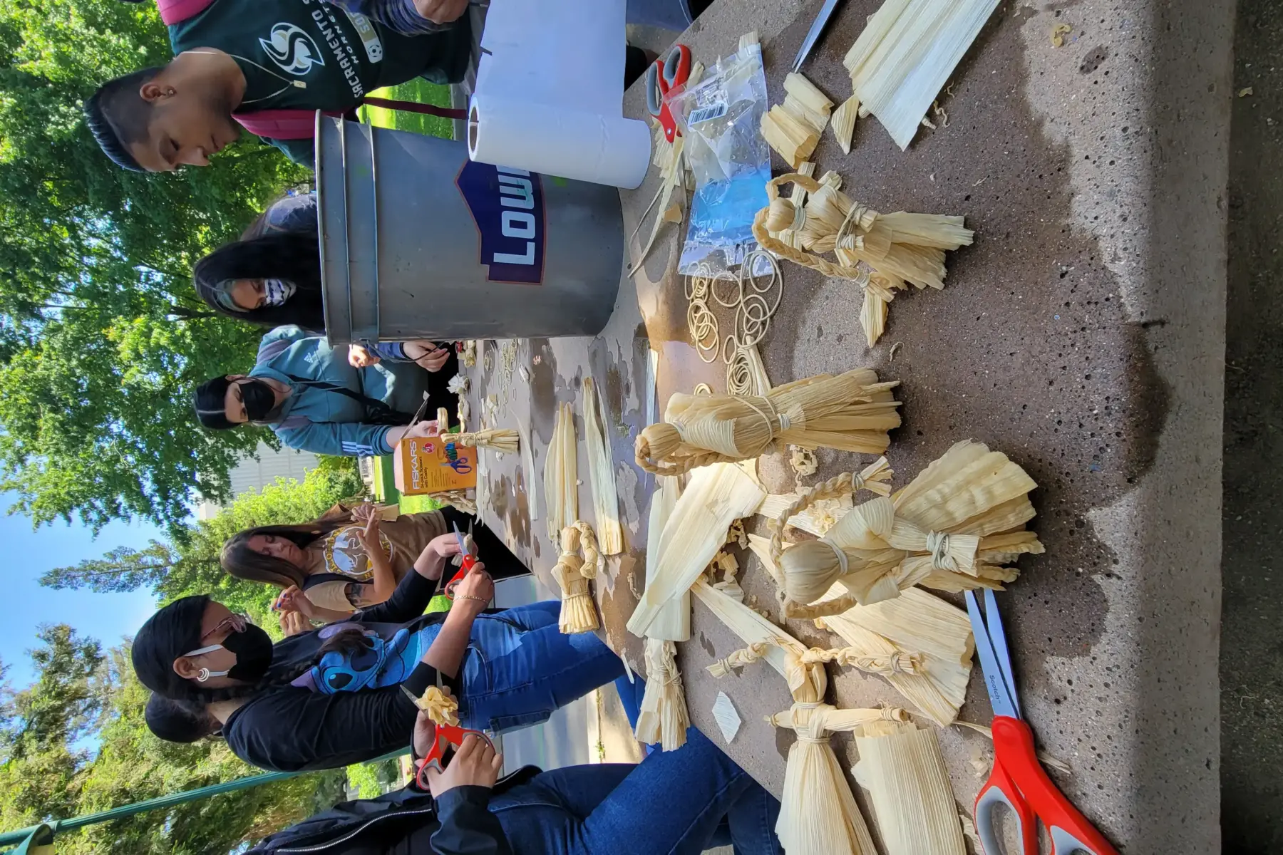 Group activity of husk dolls with students