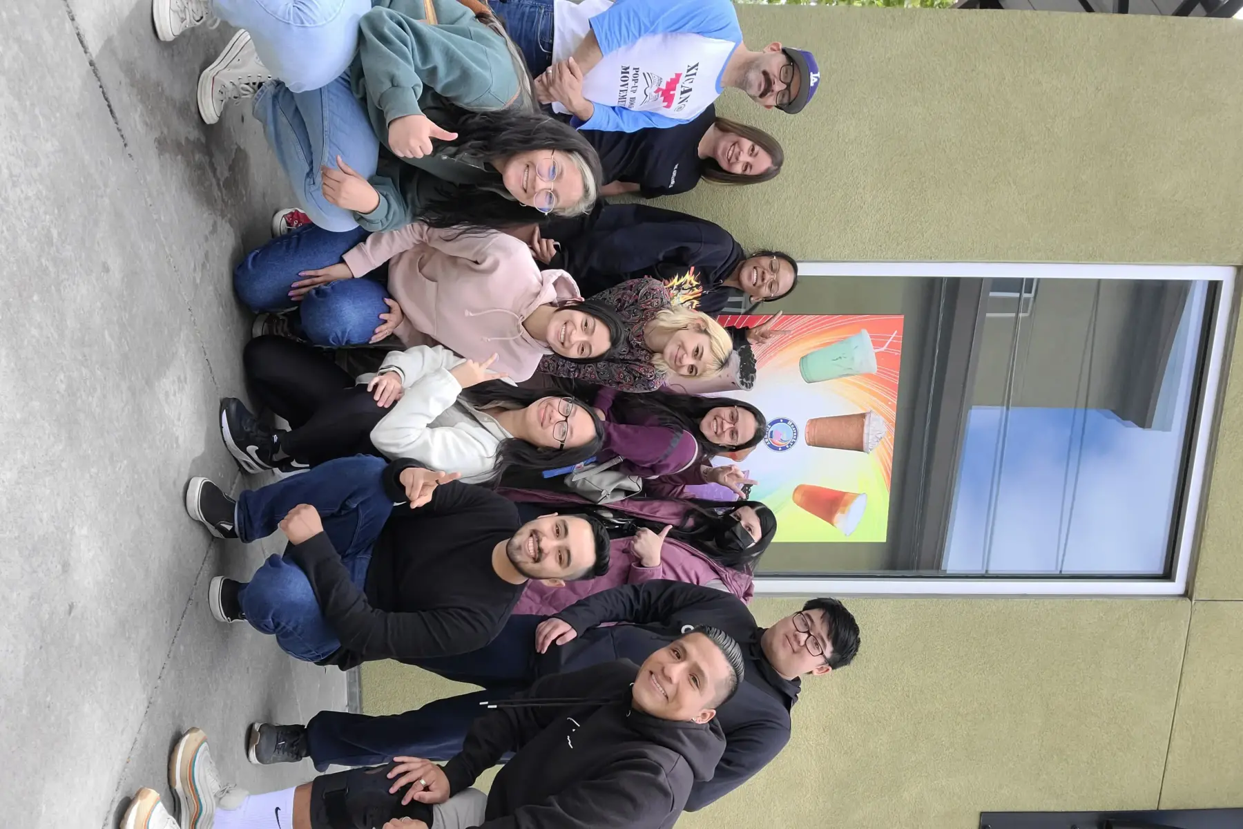 A group of students huddle together for a photo.