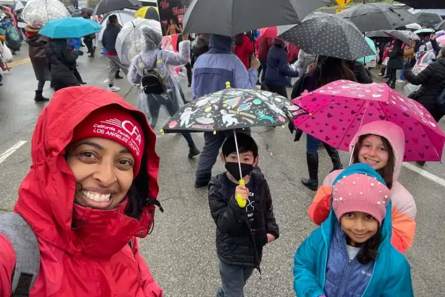 CFA member with children at the LA public school employee strike