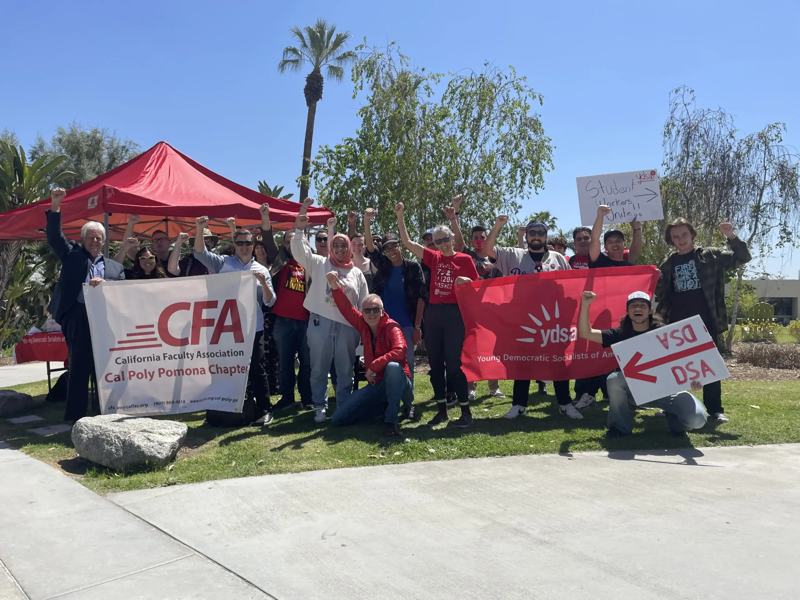 Group of people with banners and signs outdoors