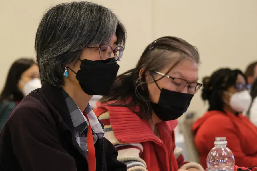 Two women in masks at CFA assembly