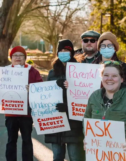 A group of people with signs outdoors