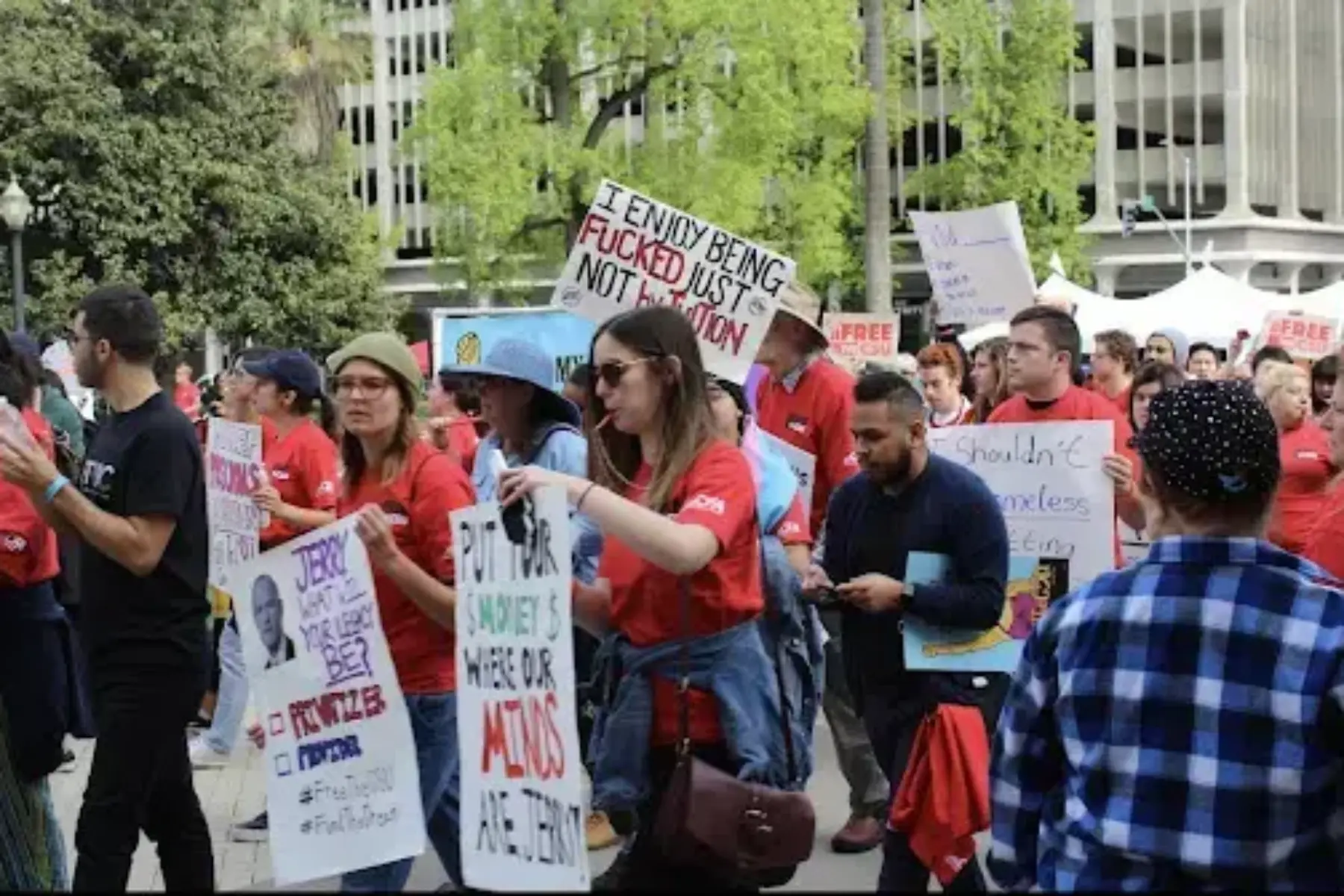 A group of people walking in a rally on April 4th to stop tuition increase.