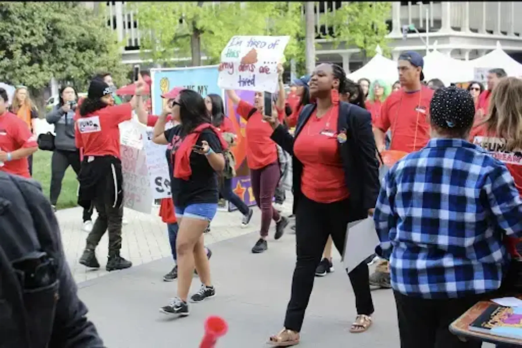 A group of people walking in a rally on April 4th to stop tuition increase.