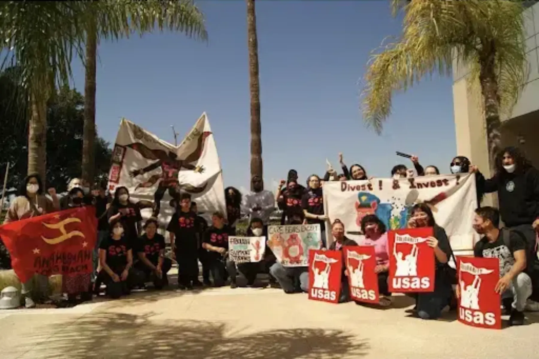 A group of students holding signs for the Board of Trustees in Long Beach.