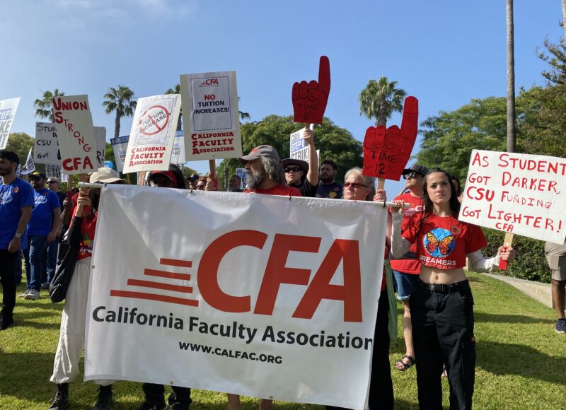 Members hold a white banner with a red logo reading CFA. A woman holds a white sign with red text that reads "As Students Got Darker, CSU Funding got Lighter! CFA"