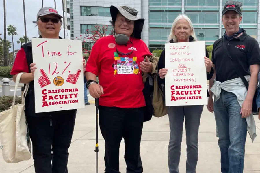 A group of CFA members in red shirts holding signs at a rally.