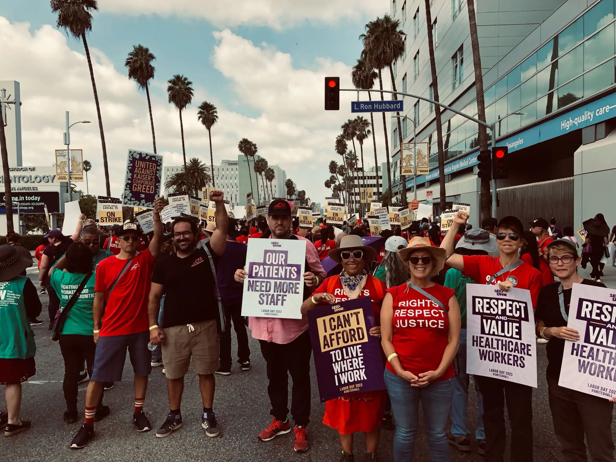 A group of members in CFA red shirts holding signs at a rally.