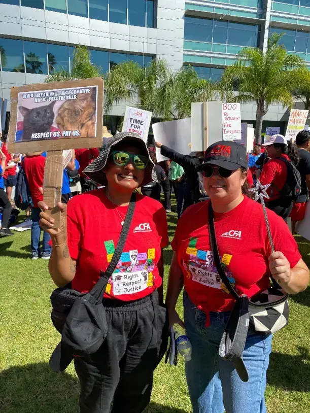 CFA members in red shirts with signs at the BoT rally with signs