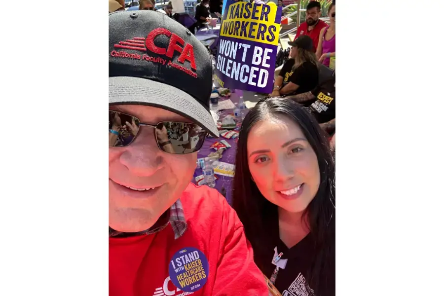 Two people take a selfie at a rally.