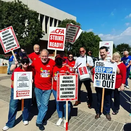 A group of people who are CFA members holding posters and signs at a rally in Long Beach.