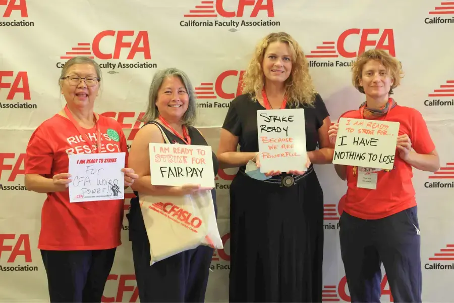 A group of cfa members hold up signs about why they are ready to strike.