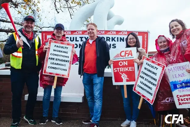 A group of CFA members outdoors with picket signs.