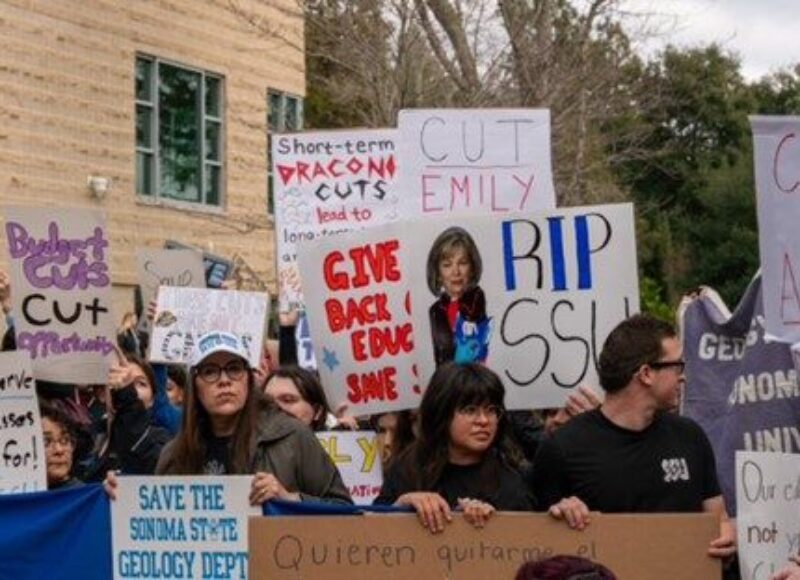 Group of people outside rallying with signs that say remove Cutrer