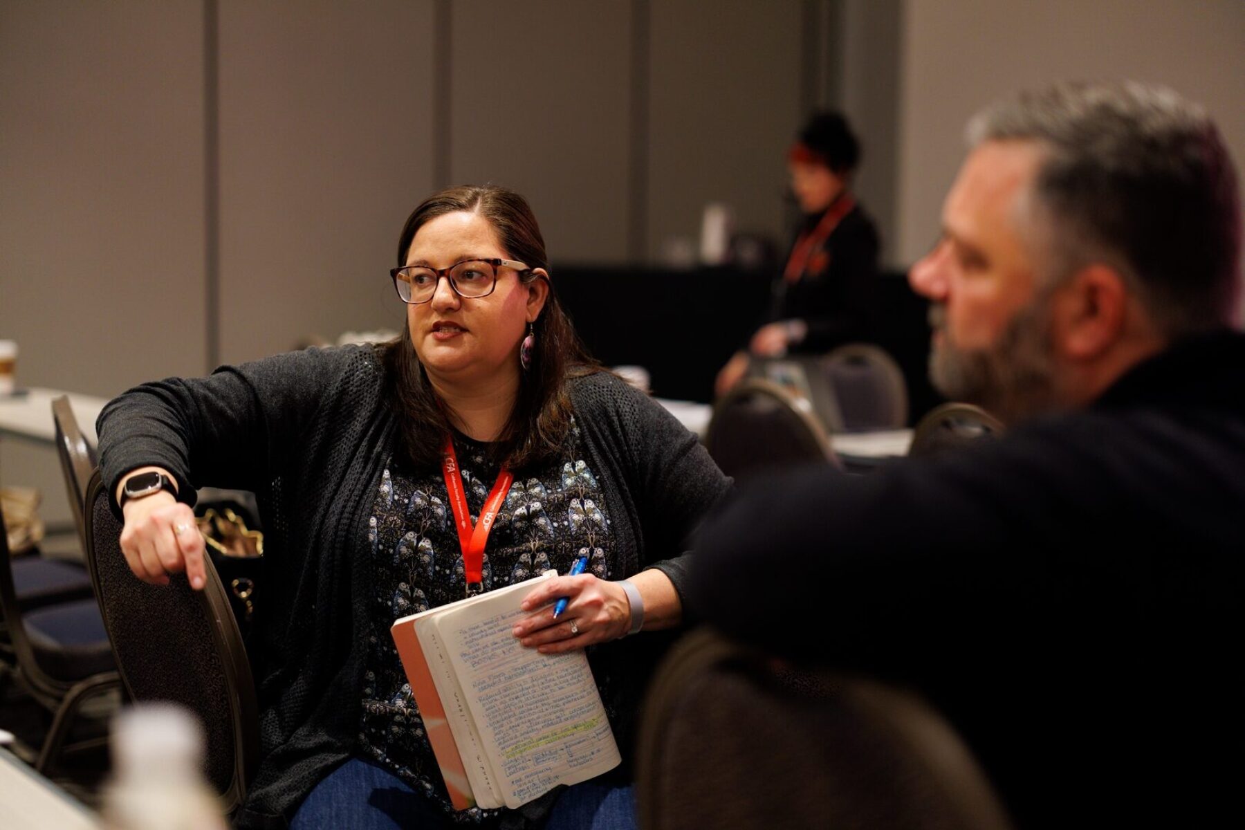 2 people in a group speaking