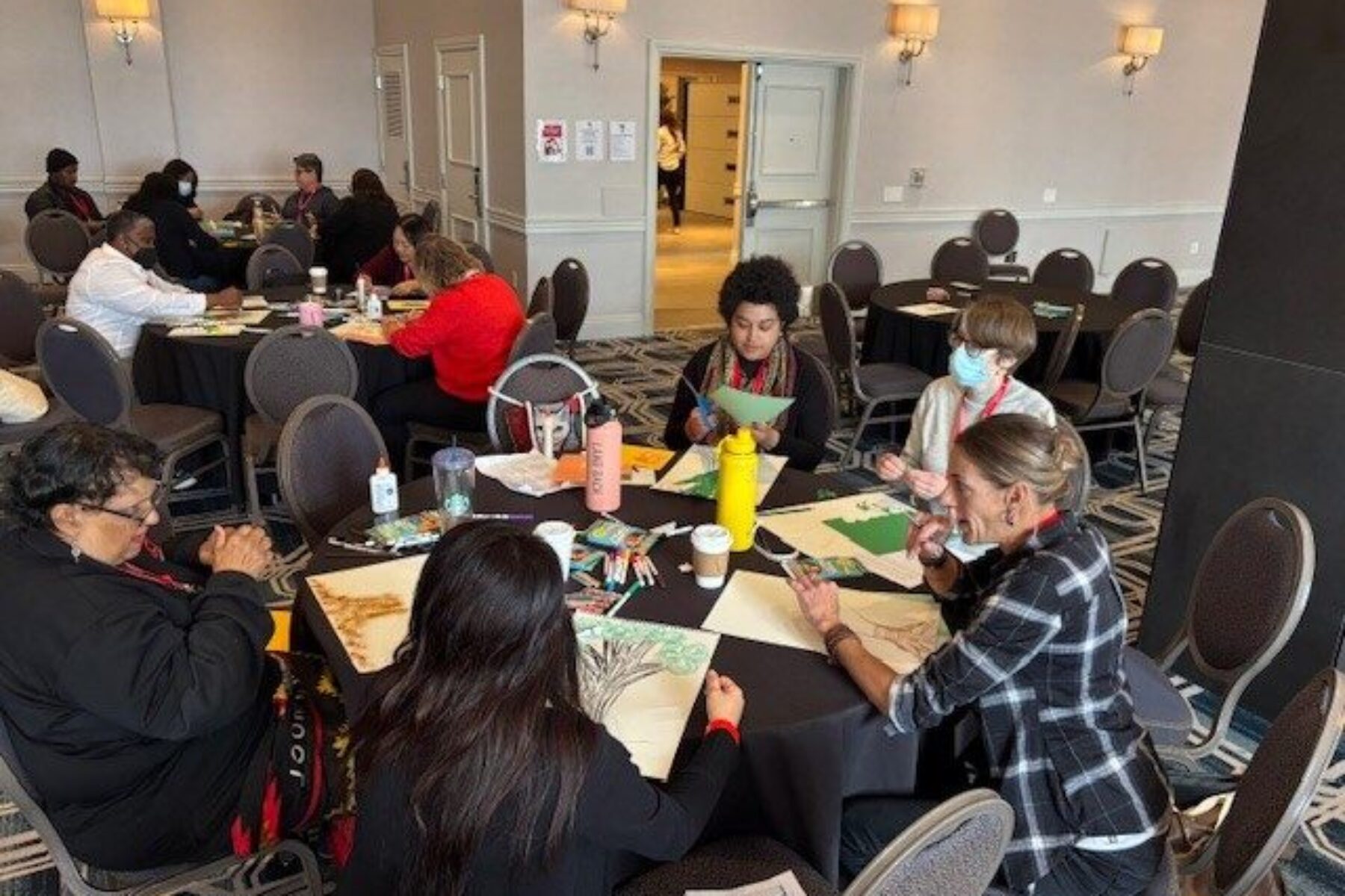 A group of people doing art projects in a workshop