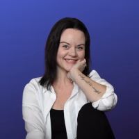 Photo of a woman in a white shirt, dark hair.