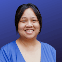 woman in a blue dress smiles for a photo