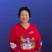 A woman with short dark hair in a red CFA shirt