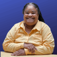person in a yellow shirt poses for a photo