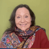 a woman with dark hair in a red blouse and scarf