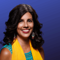 Photo of CFA President Margarita Berta Avila in a a blue blouse and yellow scarf
