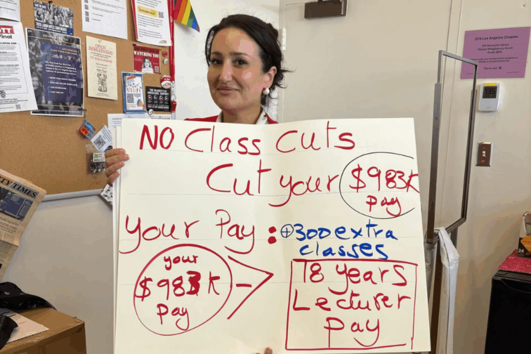 A person holds up a large sign.