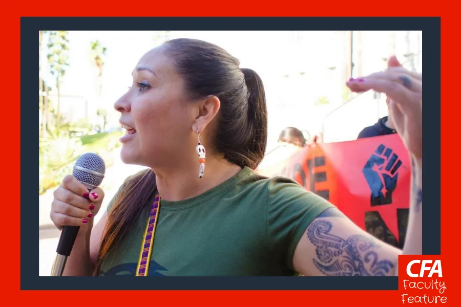 Person in a green tshirt and speaking into a microphone