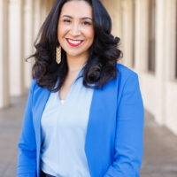 candidate in blue shirt and blue blazer with long hair