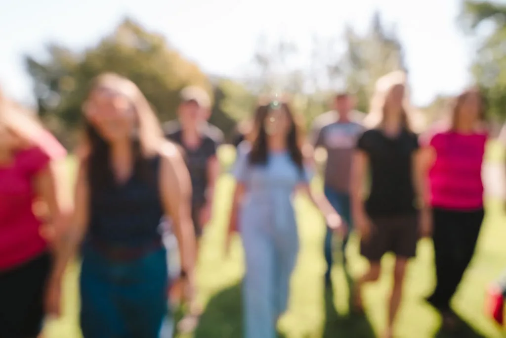 Blurry image of a group of individuals walking toward the camera in unison